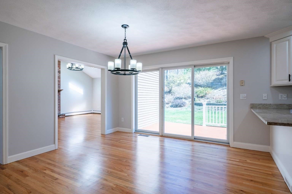 120 Bear Hill Road North Andover, MA 01845 - Photo 10 of 42 a view of empty room with wooden floor and fan