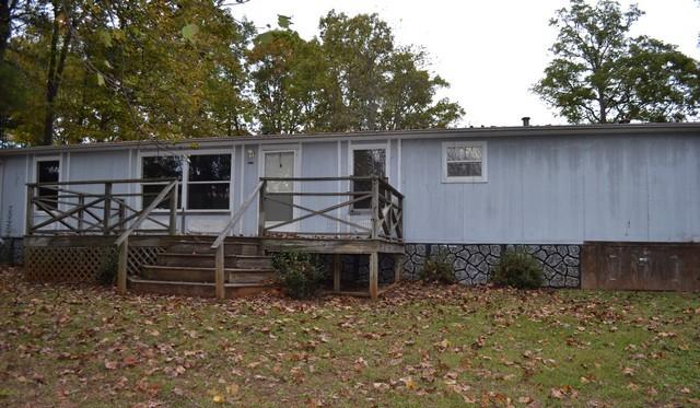 a view of a house with a bed and a table