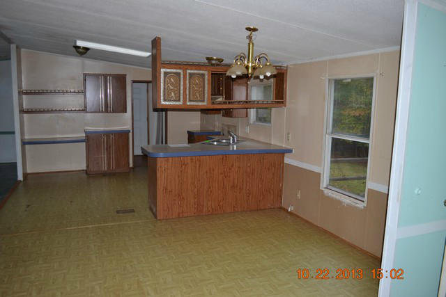 5151 Turners Creek Road Ferrum, VA 24088 - Photo 4 of 20 a room with kitchen island stainless steel appliances a chandelier
