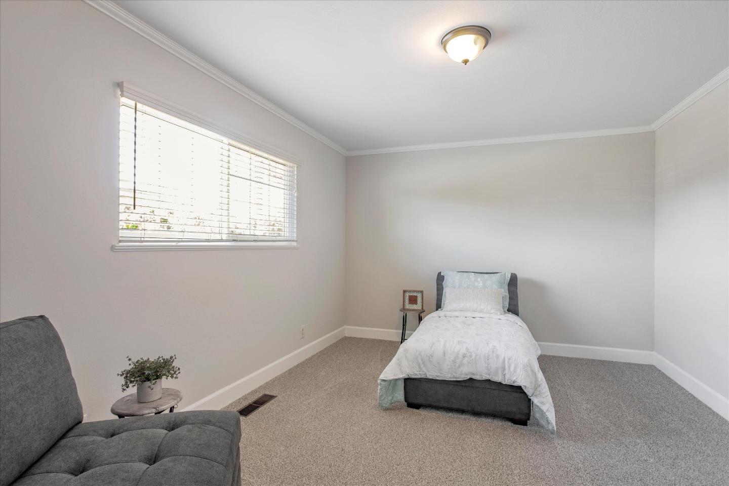 1001 Tweed Street Seaside, CA 93955 - Photo 21 of 35 a spacious bedroom with a bed and a window