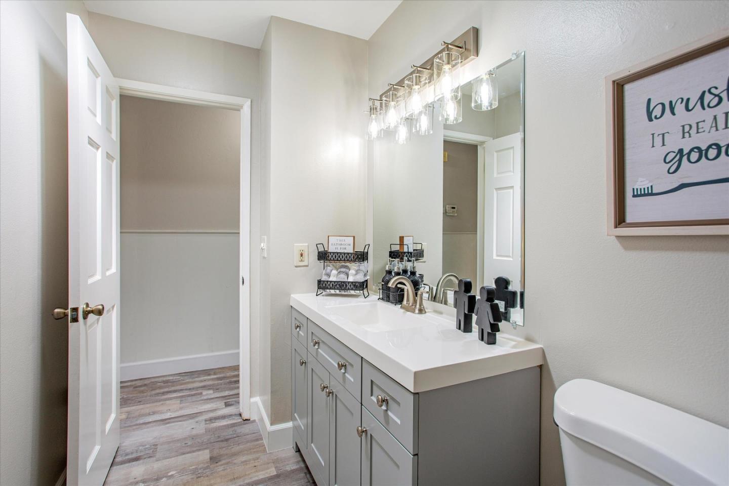 1001 Tweed Street Seaside, CA 93955 - Photo 31 of 35 a bathroom with a sink a toilet and a mirror