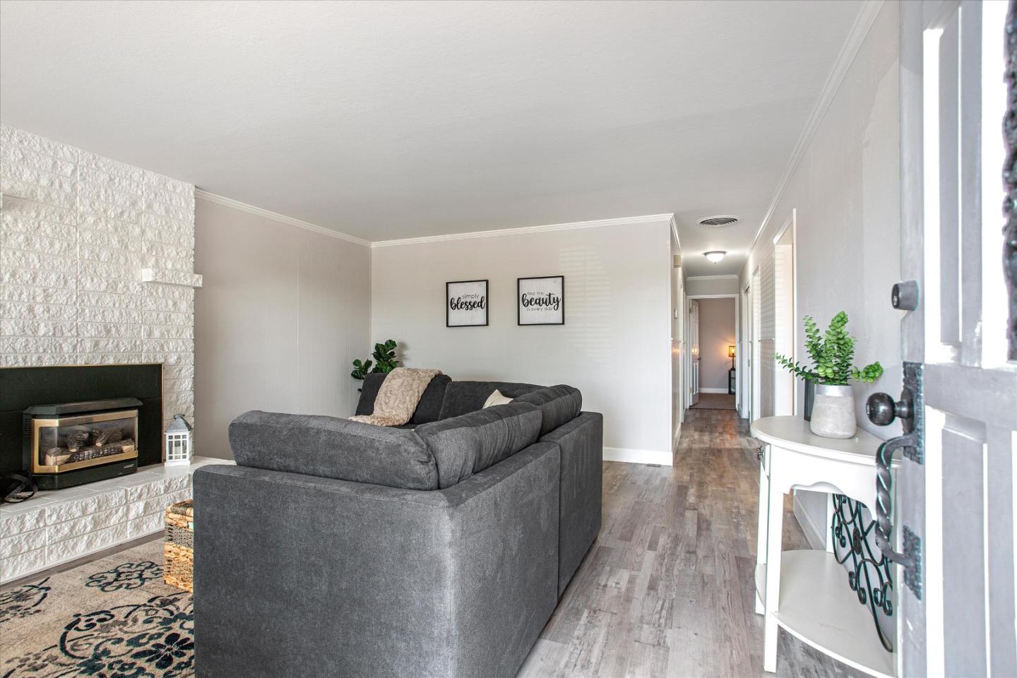 1001 Tweed Street Seaside, CA 93955 - Photo 8 of 35 a living room with furniture a flat screen tv and a fireplace