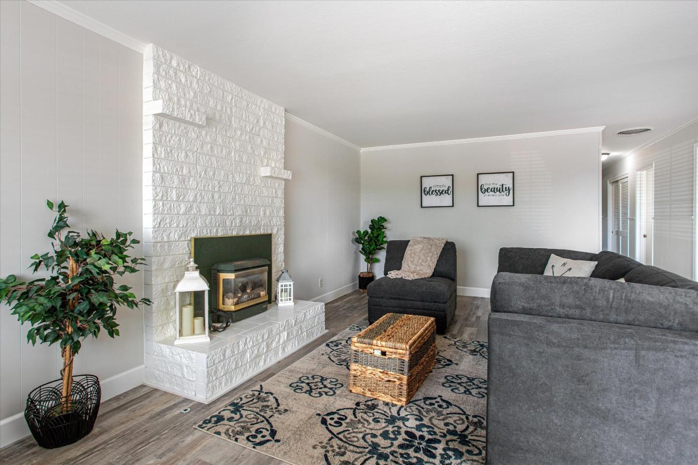 1001 Tweed Street Seaside, CA 93955 - Photo 9 of 35 a living room with furniture a potted plant and a fireplace