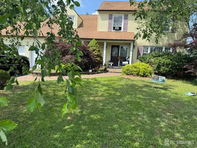 a view of a house with a yard patio and a garden