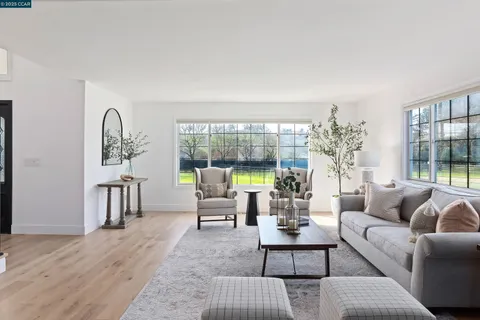 a kitchen with stainless steel appliances granite countertop a stove a sink dishwasher a microwave oven with cabinets and wooden floor