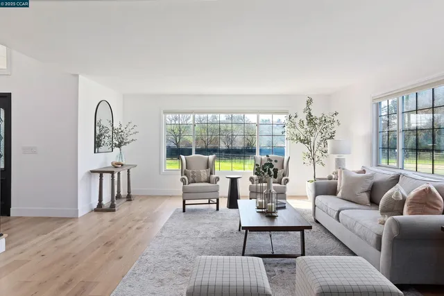 a kitchen with stainless steel appliances granite countertop a stove a sink dishwasher a microwave oven with cabinets and wooden floor