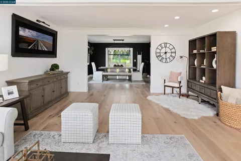 a living room with furniture a fireplace and a large window