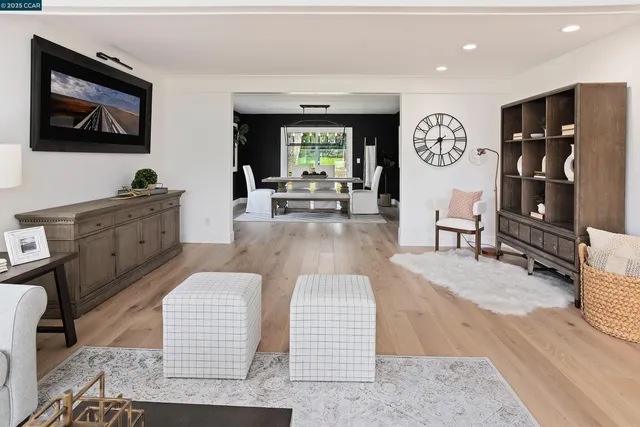 a living room with furniture a fireplace and a large window