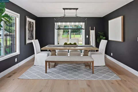 a bathroom with a toilet sink vanity tub and mirror