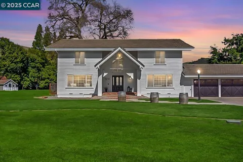 a front view of a house with a garden and porch
