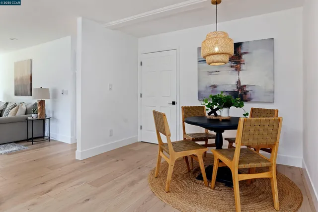 a bathroom with a granite countertop sink a large mirror a bathtub and next to a window
