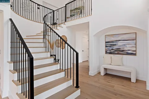 a view of a dining room with furniture wooden floor and a chandelier