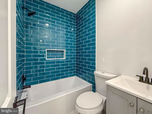 a kitchen with a refrigerator and a stove top oven