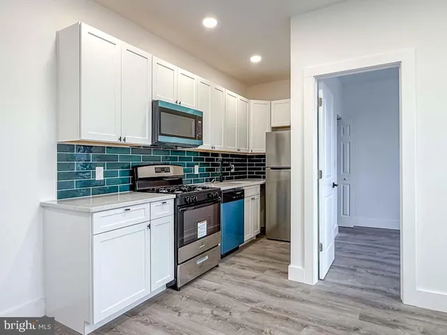a kitchen with a stove and a microwave