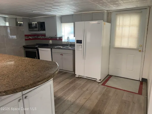 a kitchen with stainless steel appliances a refrigerator sink and stove