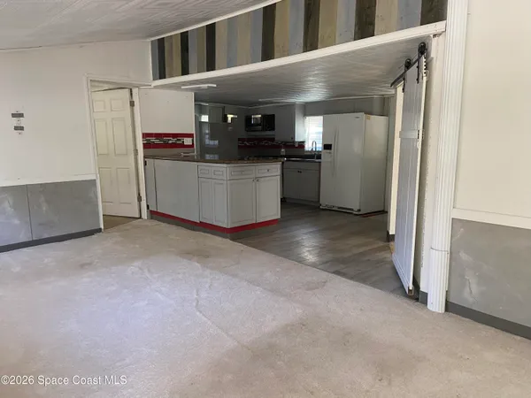 a kitchen with stainless steel appliances granite countertop a refrigerator and a stove