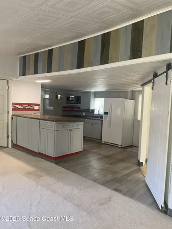 a kitchen with stainless steel appliances a stove a refrigerator and a sink
