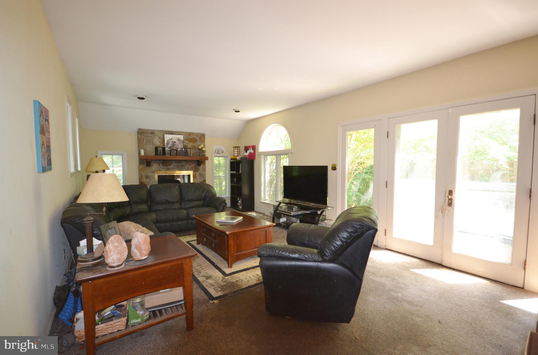 400 Upper Weadley Road Wayne, PA 19087 - Photo 14 of 15 Family Room with Fireplace and Doors to Patio