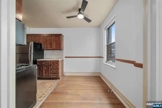 a view of a room with wooden floor
