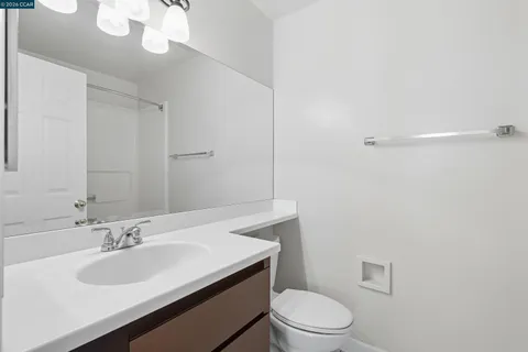 a bathroom with a sink a toilet and a mirror