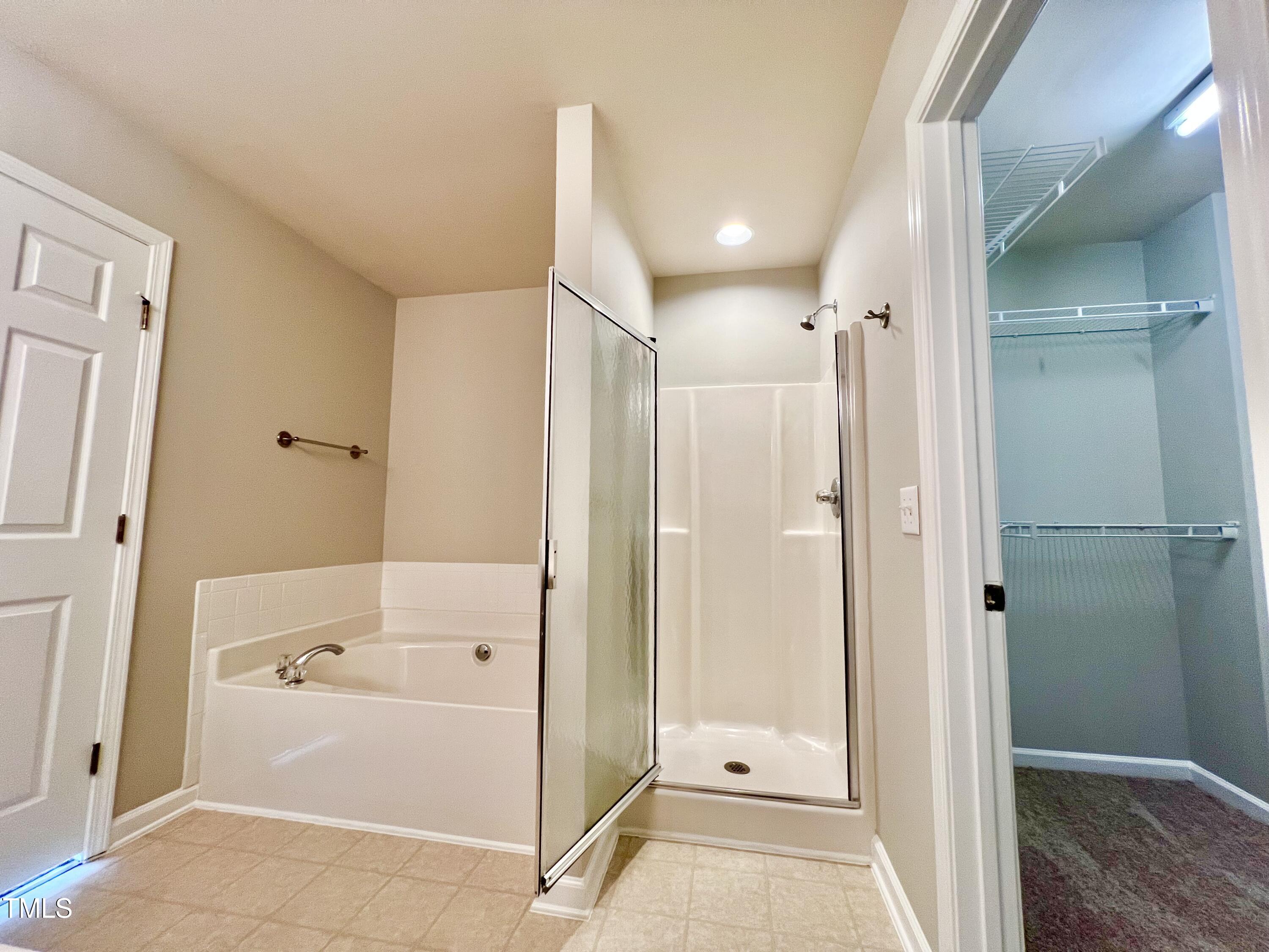 2118 Kedvale Avenue Raleigh, NC 27617 - Photo 13 of 17 a bathroom with a glass shower door