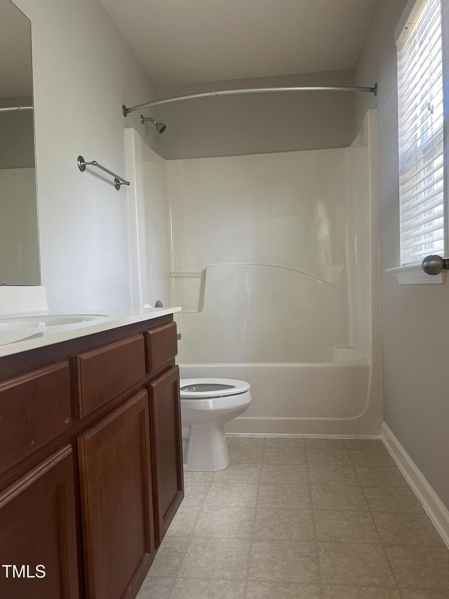 2118 Kedvale Avenue Raleigh, NC 27617 - Photo 15 of 17 a bathroom with a sink a toilet and shower