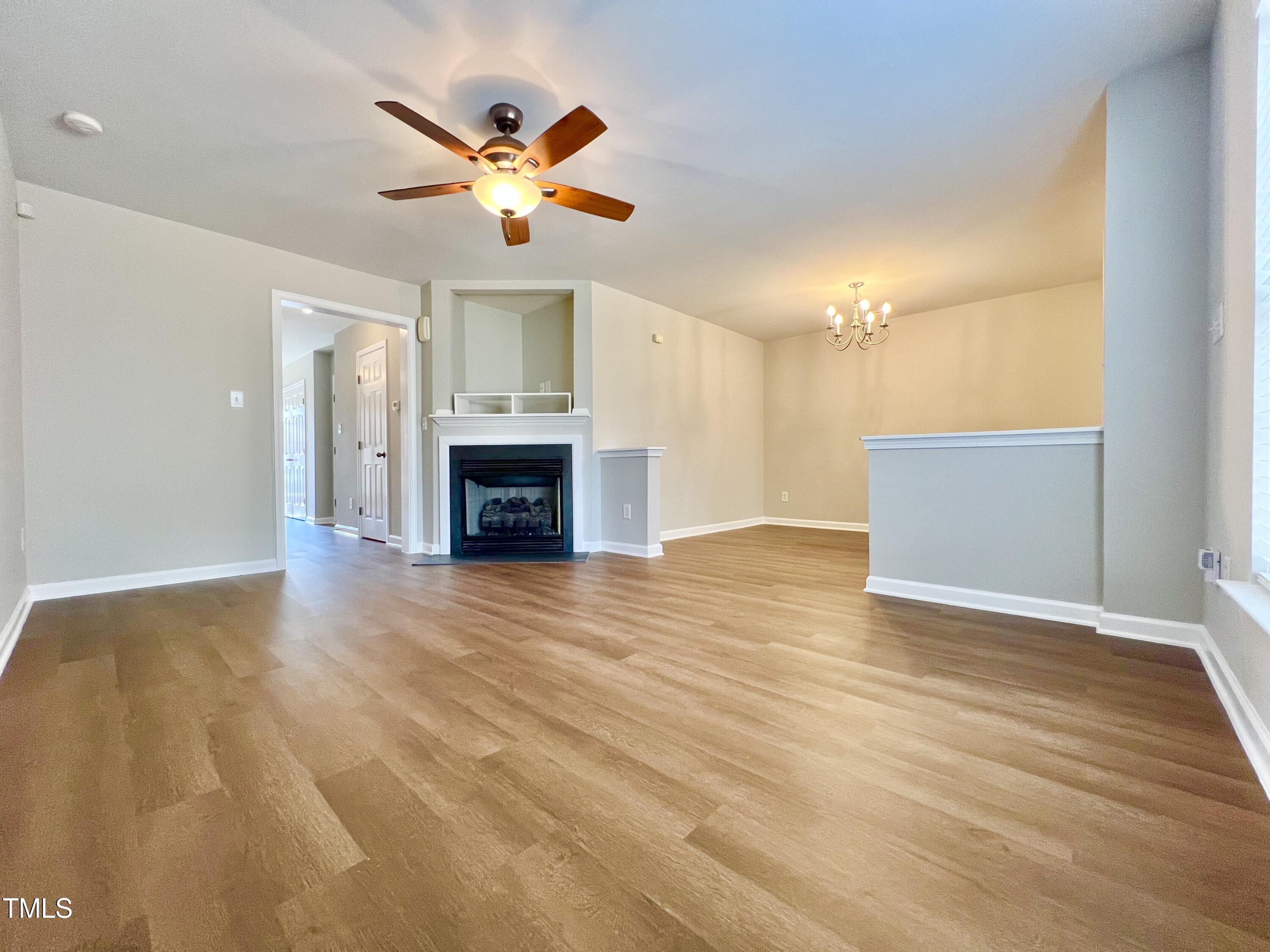 2118 Kedvale Avenue Raleigh, NC 27617 - Photo 4 of 17 wooden floor in an empty room with a ceiling fan and window