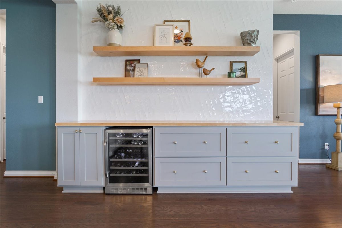 424 Millard Street Georgetown, TX 78628 - Photo 8 of 37 Custom cabinetry and floating wood shelves create an elegant display and functional storage.