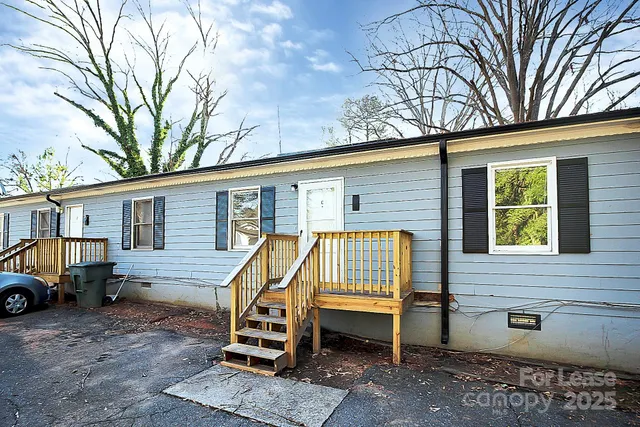 a view of backyard with a car parked in a patio