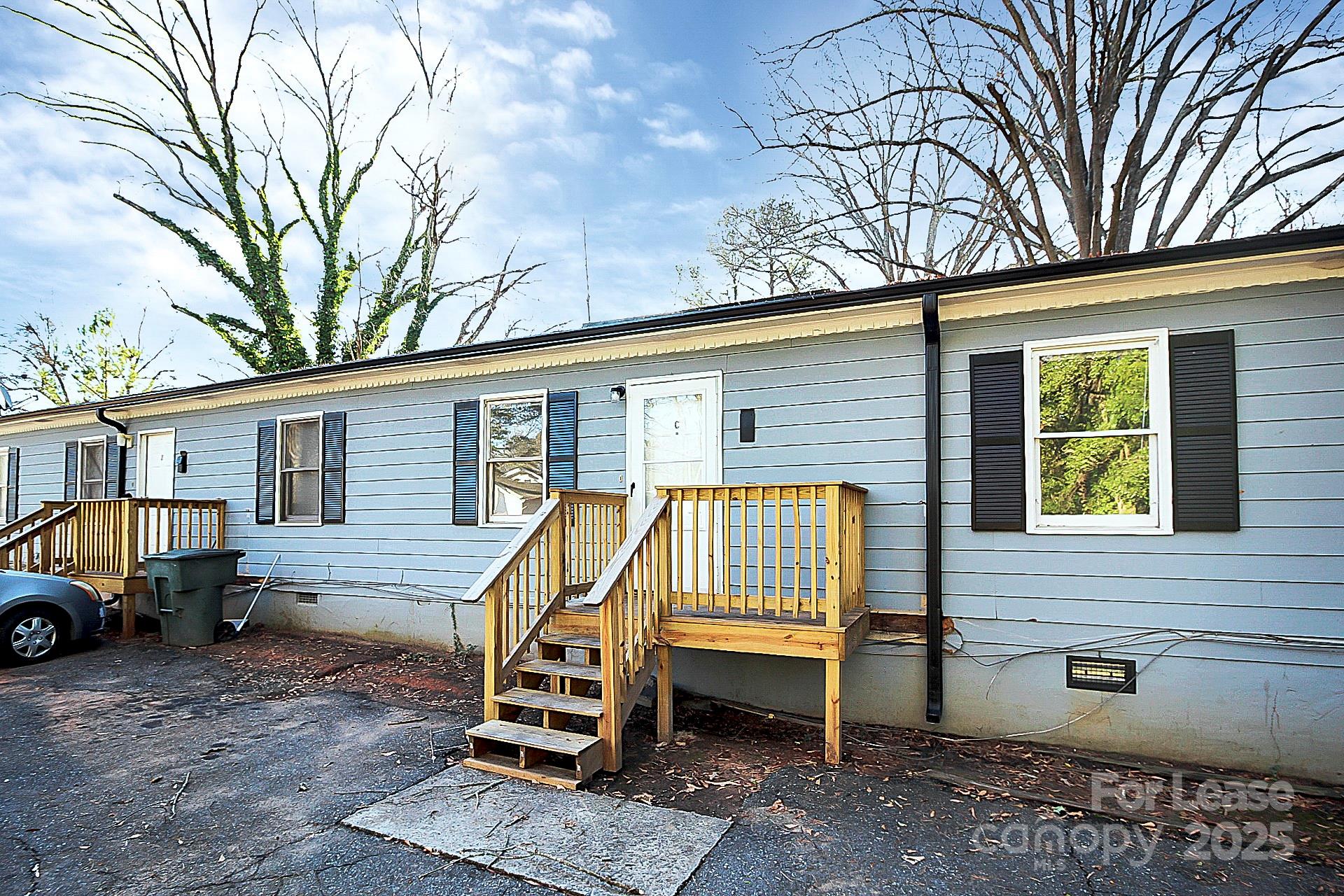 a view of backyard with a car parked in a patio