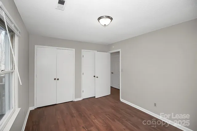 a view of room with window and hardwood floor