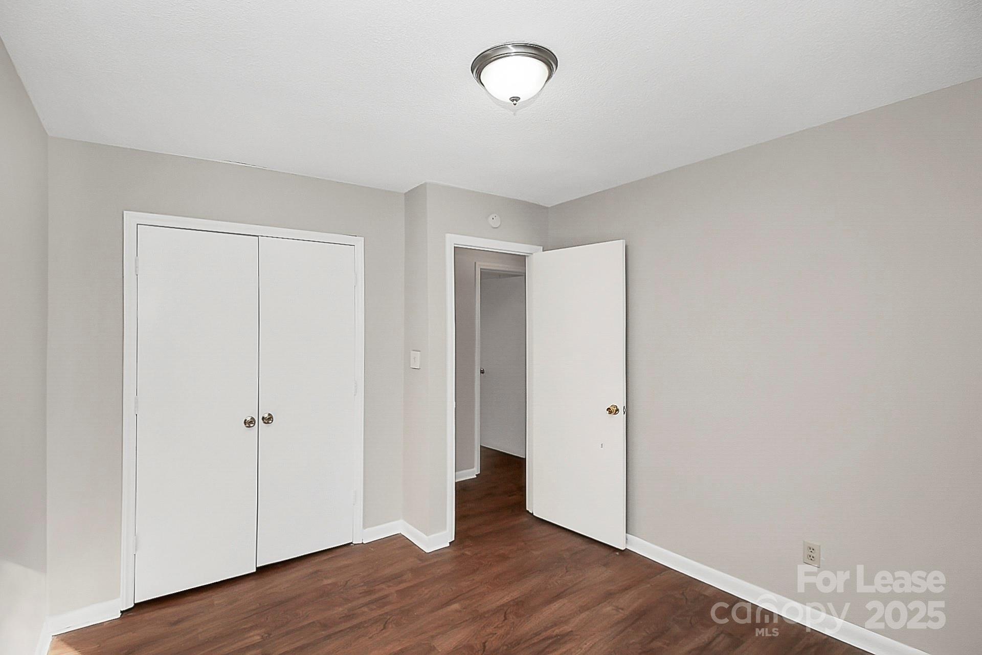501 North Ransom Street, Unit C Gastonia, NC 28052 - Photo 16 of 19 an empty room with wooden floor and closet