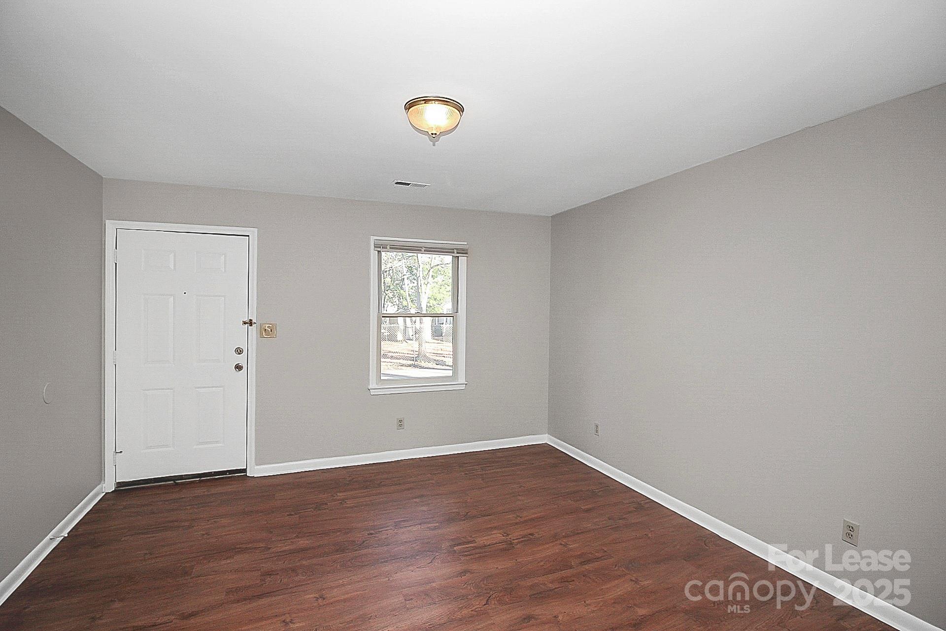 501 North Ransom Street, Unit C Gastonia, NC 28052 - Photo 2 of 19 a view of a livingroom with wooden floor and window