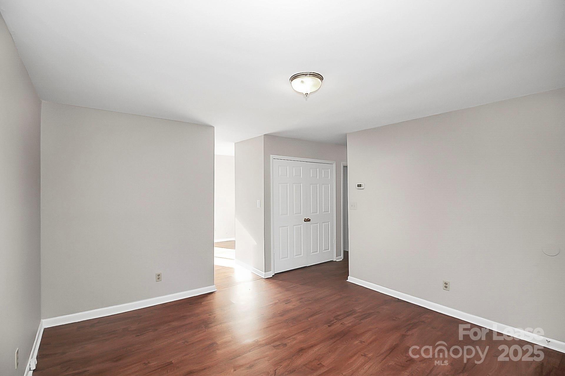 501 North Ransom Street, Unit C Gastonia, NC 28052 - Photo 4 of 19 a view of an empty room with wooden floor