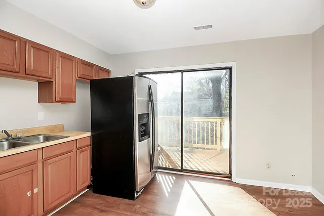 a kitchen with a refrigerator and cabinets