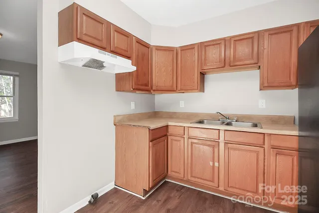 a kitchen with sink cabinets and window