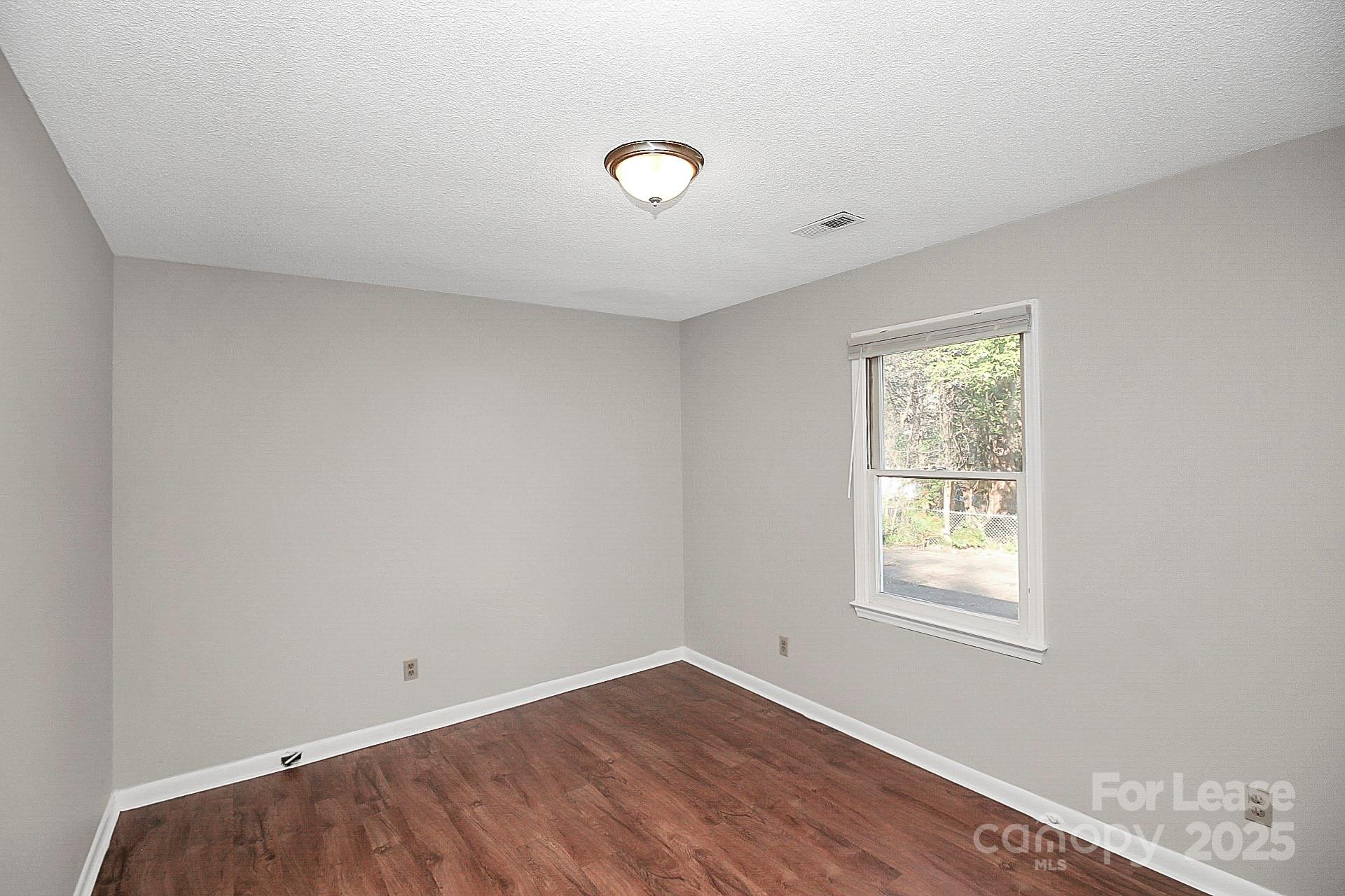 501 North Ransom Street, Unit C Gastonia, NC 28052 - Photo 10 of 19 an empty room with a window