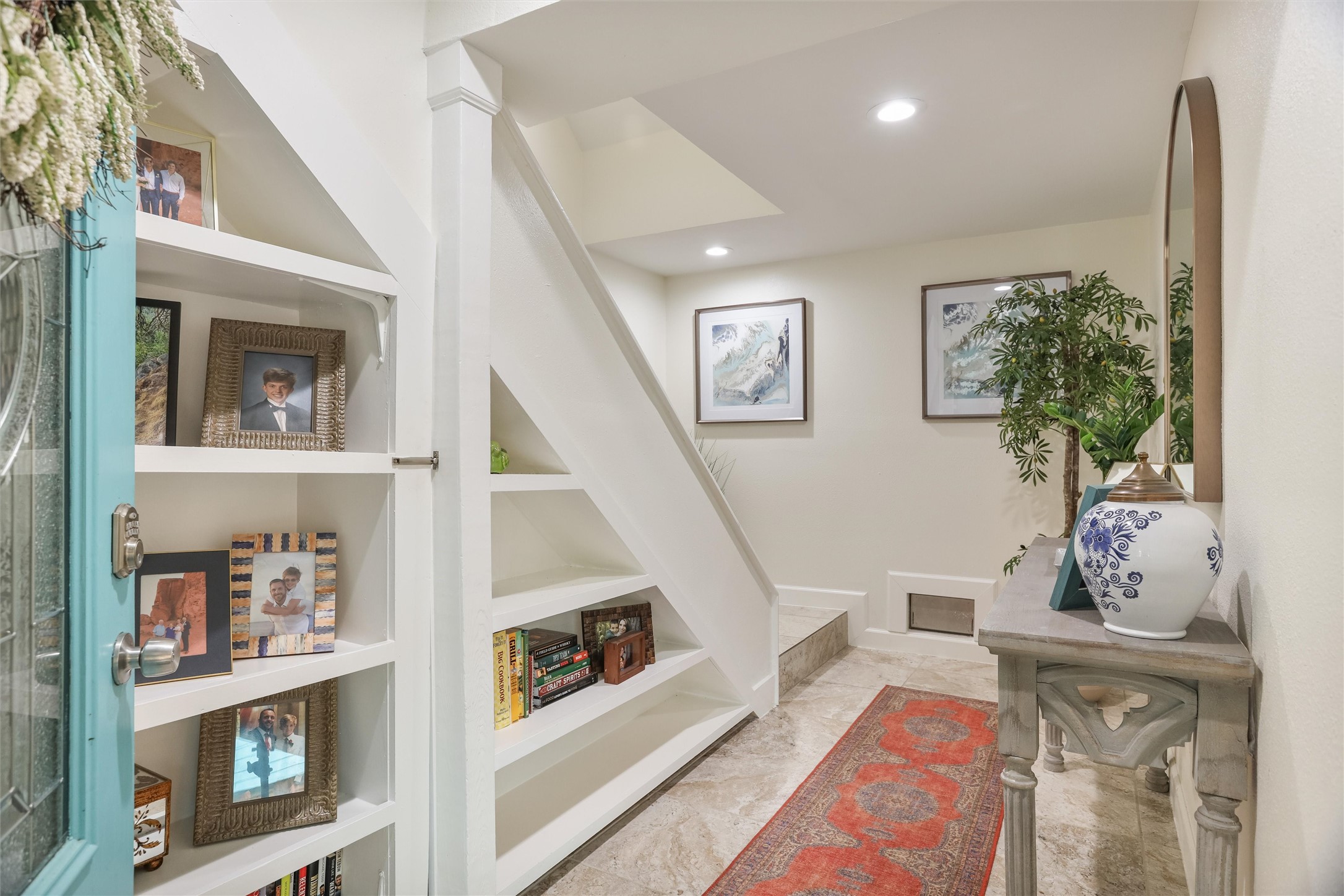 224 Clear Lake Road Clear Lake Shores, TX 77565 - Photo 12 of 50 Entry to home with built in bookshelves and under stairs storage.