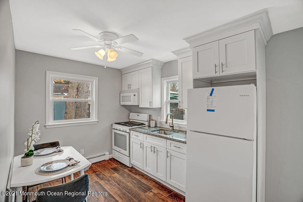 140 Pinehurst Road Brick, NJ 08723 - Photo 11 of 13 a kitchen with stainless steel appliances granite countertop a refrigerator stove sink and cabinets