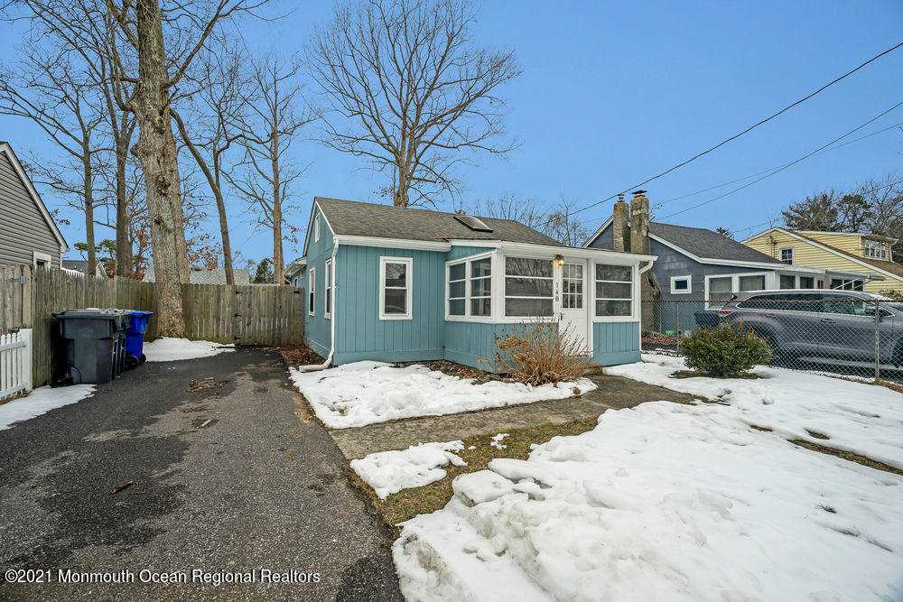 140 Pinehurst Road Brick, NJ 08723 - Photo 3 of 13 a view of a blue house with snow on the road