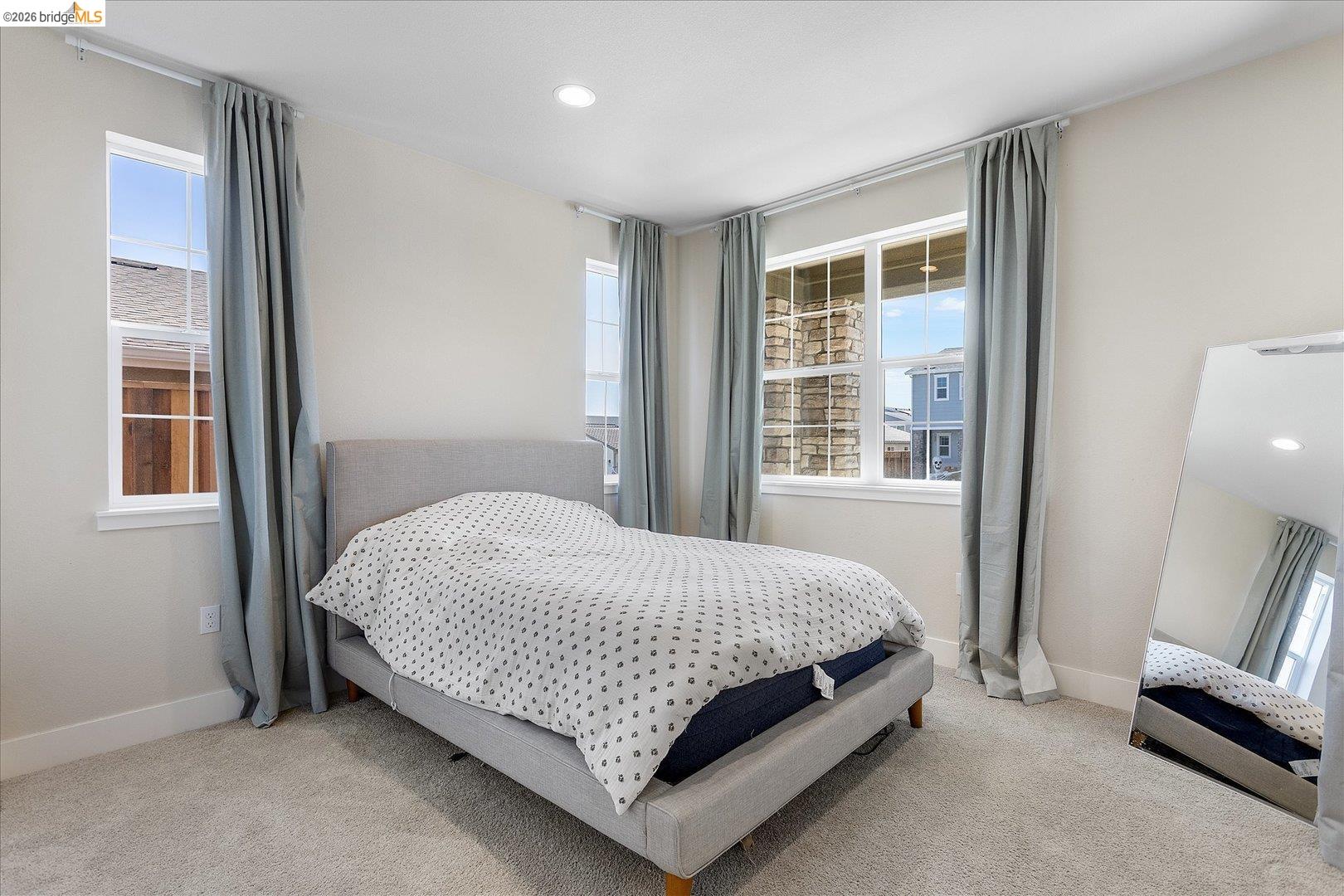 5601 Ridgepoint Way Antioch, CA 94531 - Photo 22 of 59 Spacious room featuring multiple large windows, recessed lighting, neutral wall tones, and plush carpeting