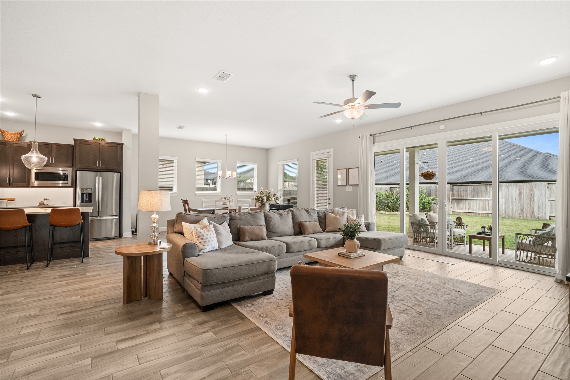 3118 Swift Way Katy, TX 77493 - Photo 12 of 34 Living Room (Alternate View) – Expansive layout connects the living space to the kitchen and dining areas, highlighted by modern finishes and durable wood-look tile flooring.