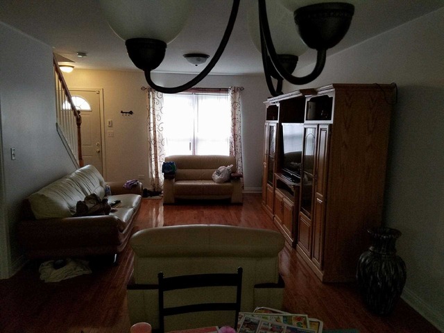 238 Chippewa Court, Unit A Bolingbrook, IL 60440 - Photo 2 of 8 a living room with furniture and a flat screen tv