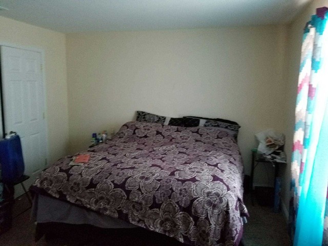 238 Chippewa Court, Unit A Bolingbrook, IL 60440 - Photo 4 of 8 a bed sitting in a bedroom next to a window