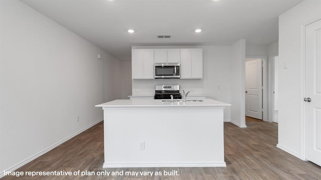 a kitchen with a sink a stove and cabinets