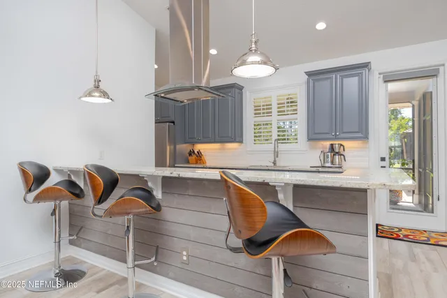 a large kitchen with stainless steel appliances kitchen island granite countertop a sink and cabinets
