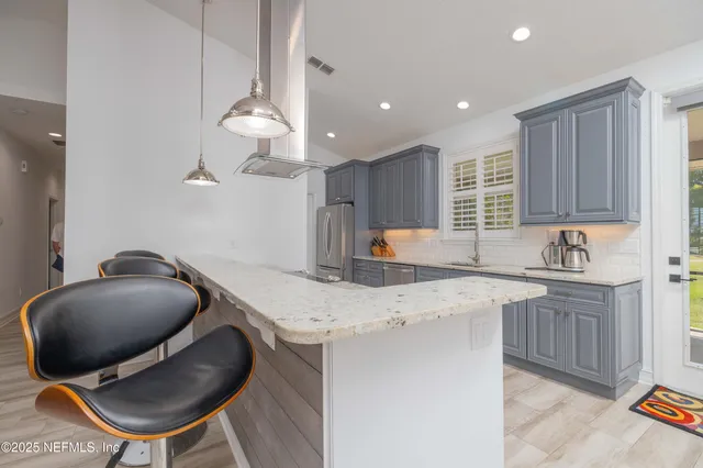 a kitchen with granite countertop a sink and a window