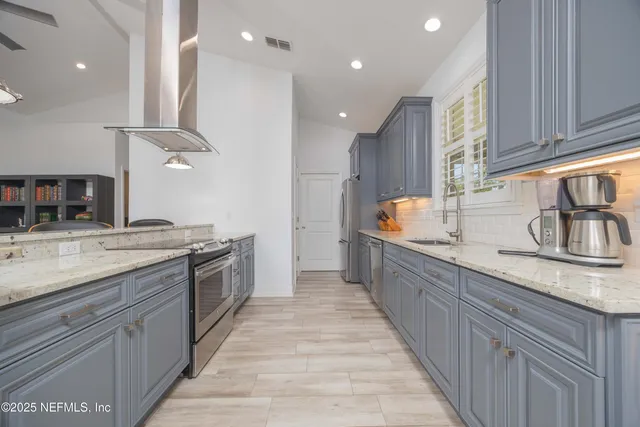 a living room with patio furniture and a floor to ceiling window