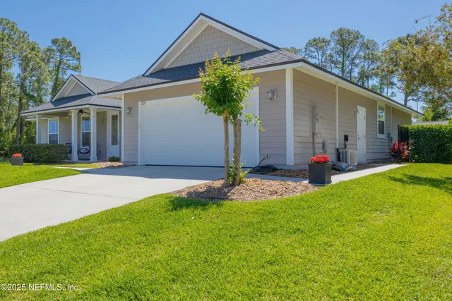 a front view of a house with a garden and yard