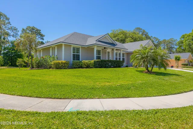 a living room with furniture a couch and a large window